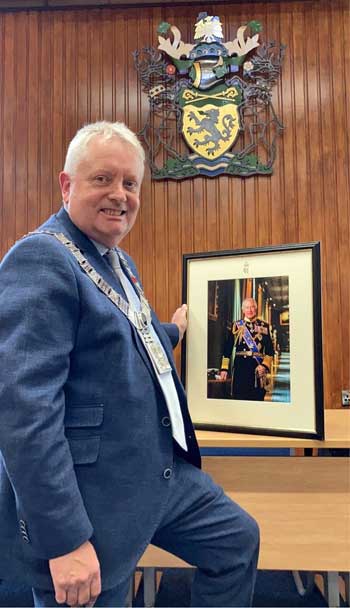 Ribble Valley Mayor Mark Hindle with the official portrait of His Majesty King Charles III.