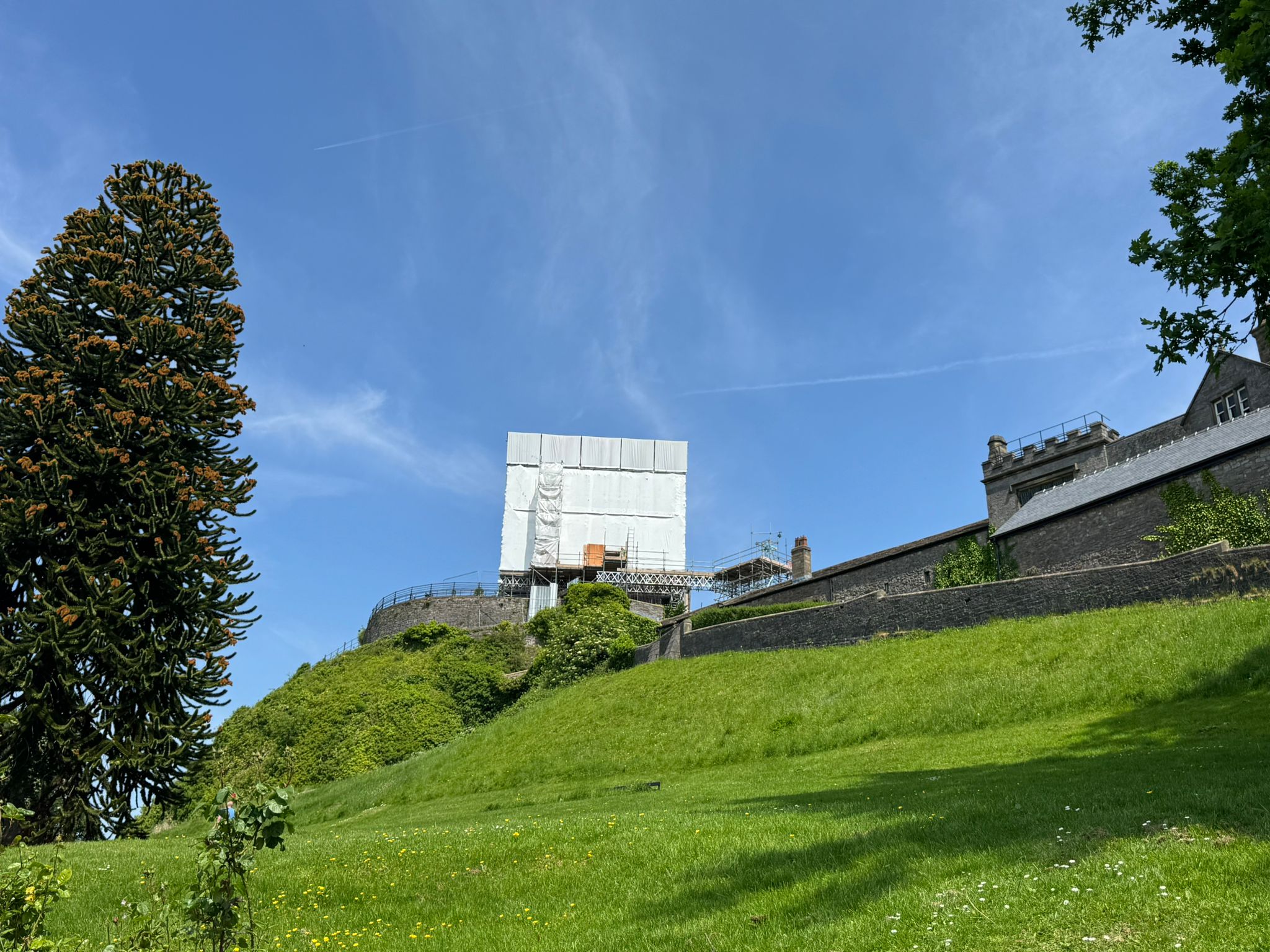 Clitheroe castle covered in a tarp on a sunny day