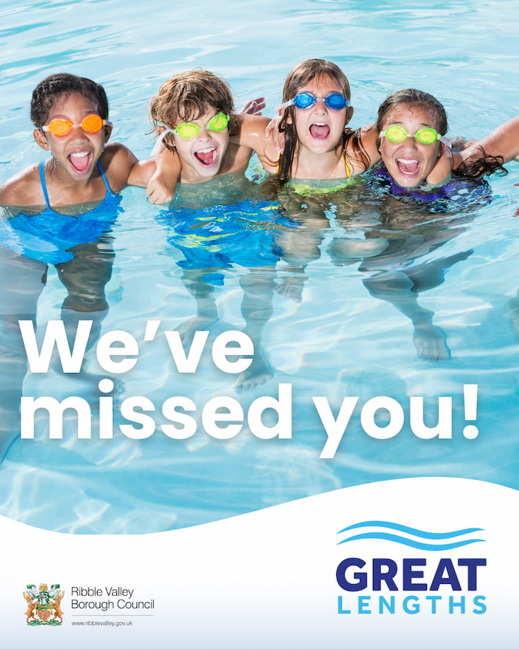 Four smiling children in a swimming pool