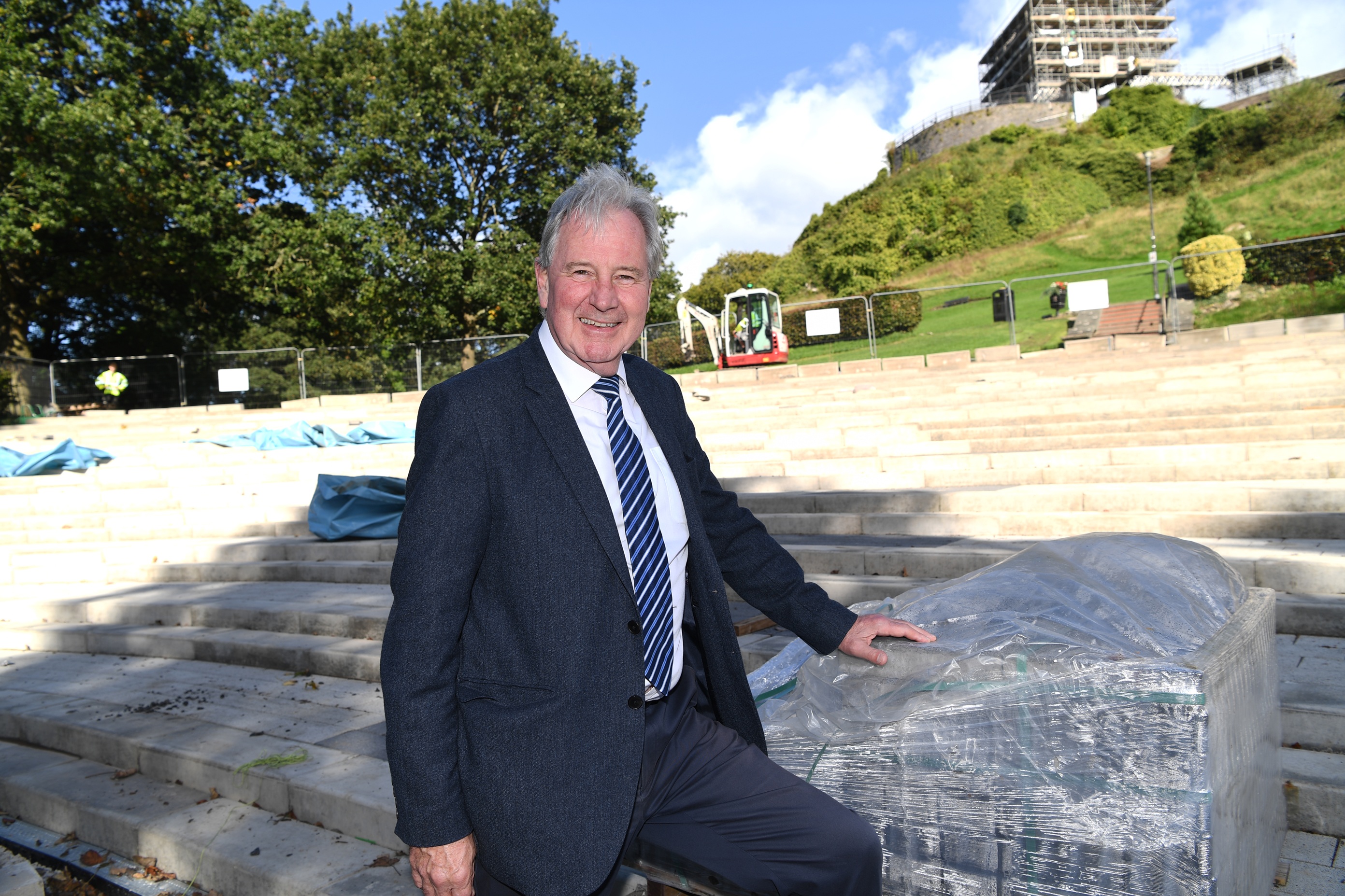 Councillor Stuart Hirst stood on the in progress seating for Clitheroe Castle Bandstand.