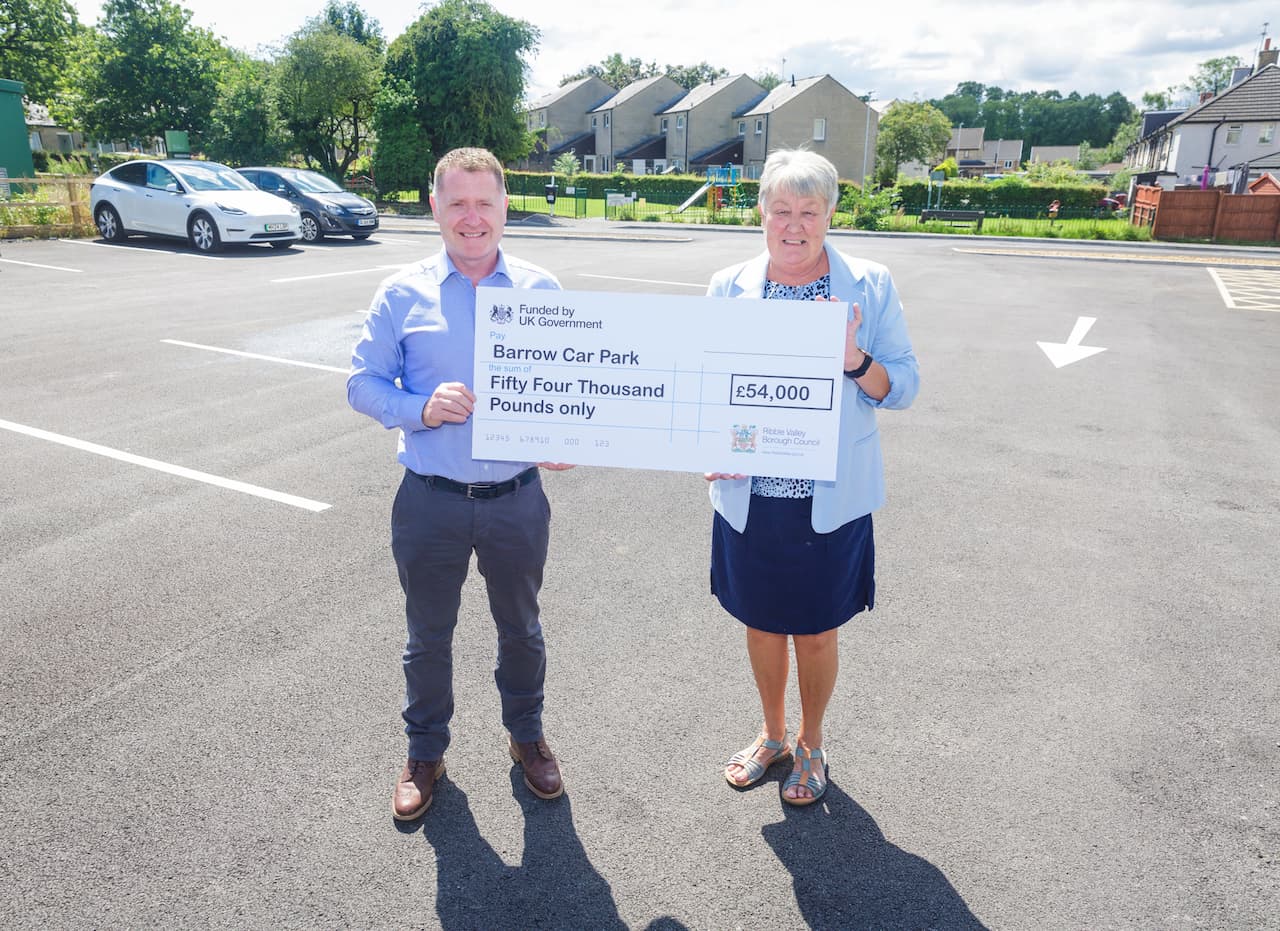 RVBC Councillor Street with Barrow parish councillor Karen Heyworth holding an oversized cheque for the car park improvement works.