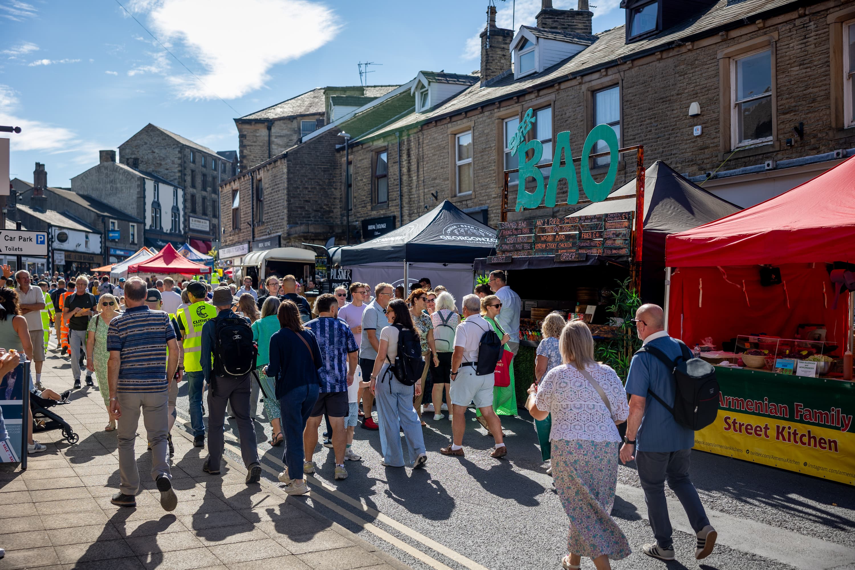 King Street in Clitheroe during the annual food festival. There are stalls in the road and crowds for people.