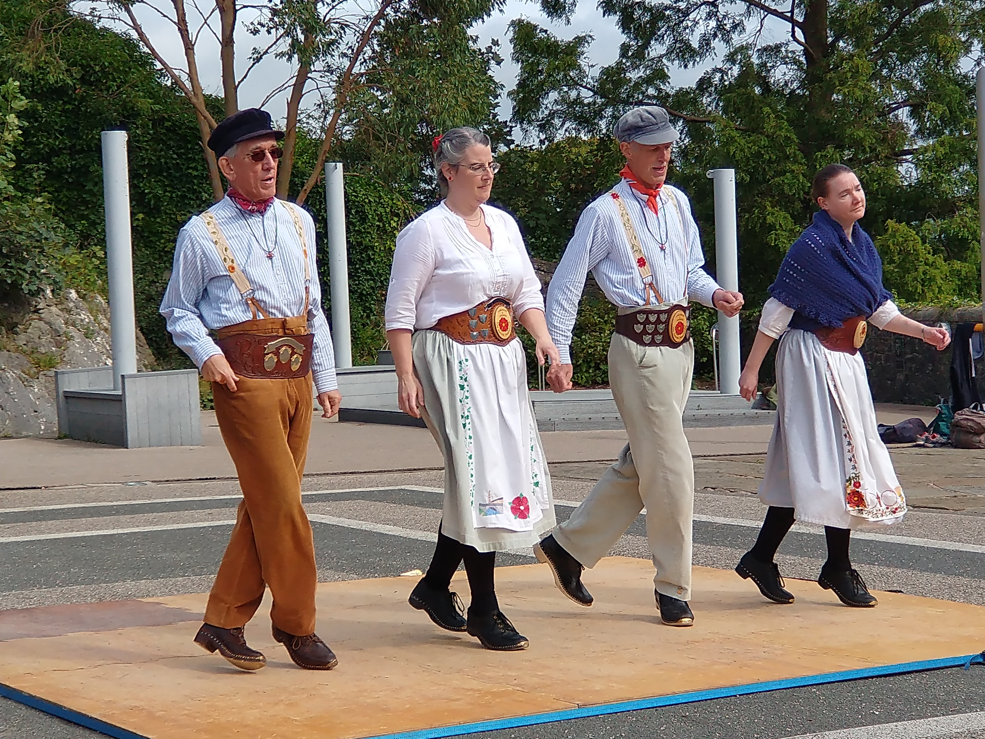 Four clog dancers from the Lancashire Wallopers performing a clog dance.
