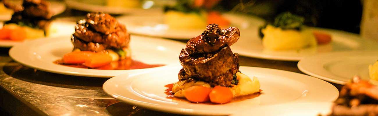 Food being served underneath a plate warmer