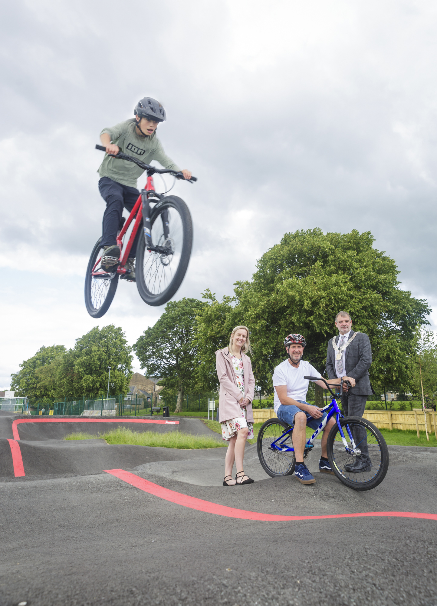 A shot of a child on a bike mid-jump from a ramp.
