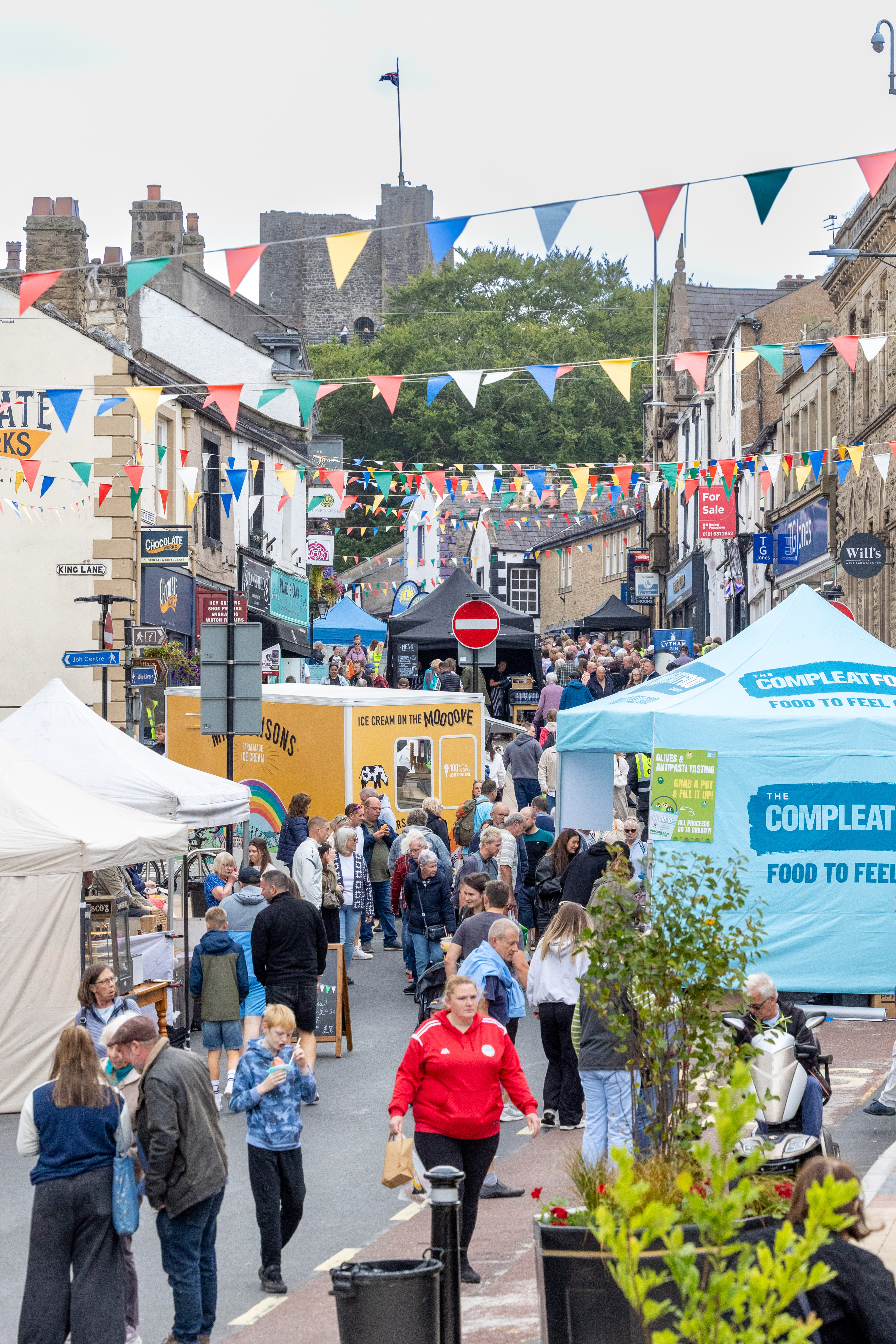 A busy shot of Castle Street Clitheroe during the Food Festival. Marquees are setup along the road.