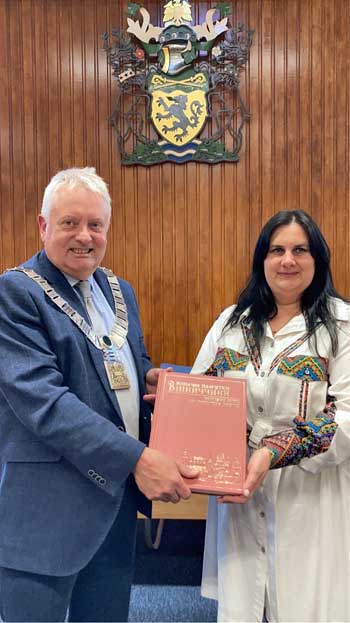 Ribble Valley Mayor Mark Hindle is pictured with Olha Vazhova, head teacher at School 4 in Vinnystia, Ukraine, presented him with a book printed in Ukrainian and English showing the country’s many regional heritage sites.