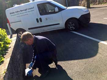 Pest control officer laying a bait box