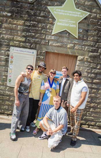 Coky Giedroyc and the actors and dancers who play the boy band