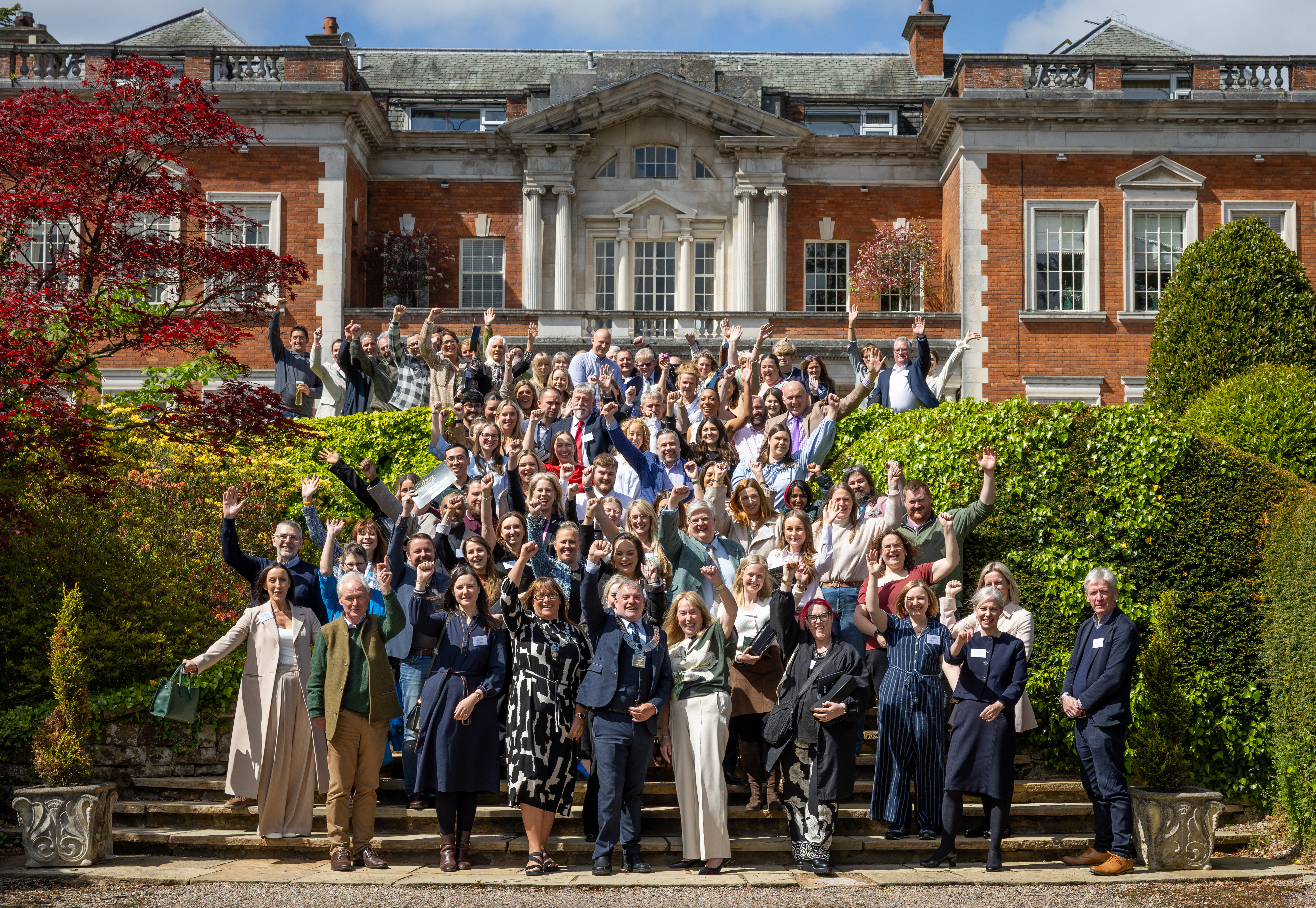 A large crowd of people outside a stately building celebrating the annual Ribble Valley Tourism Awards.