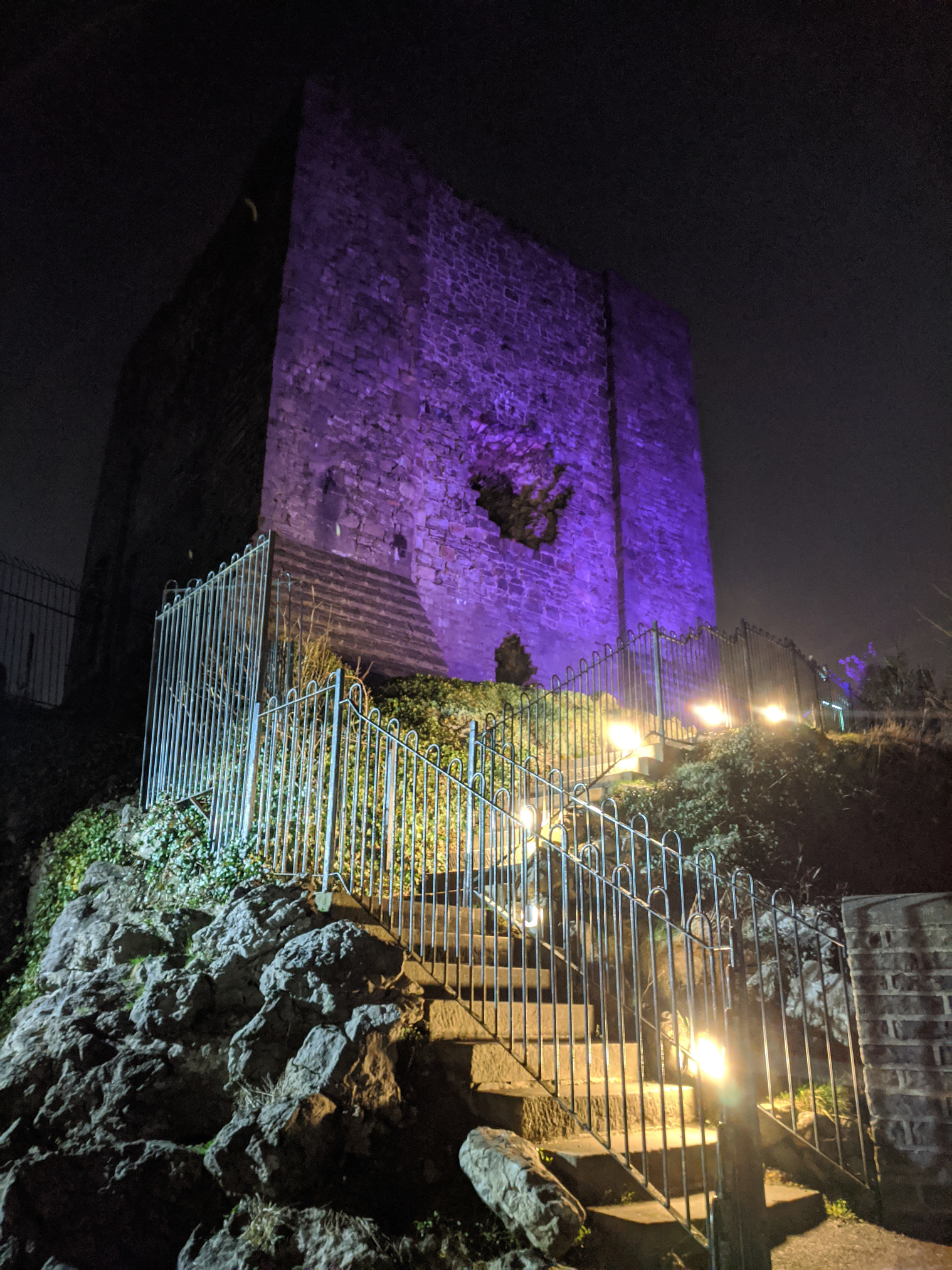 Clitheroe Castle lit up in purple at night