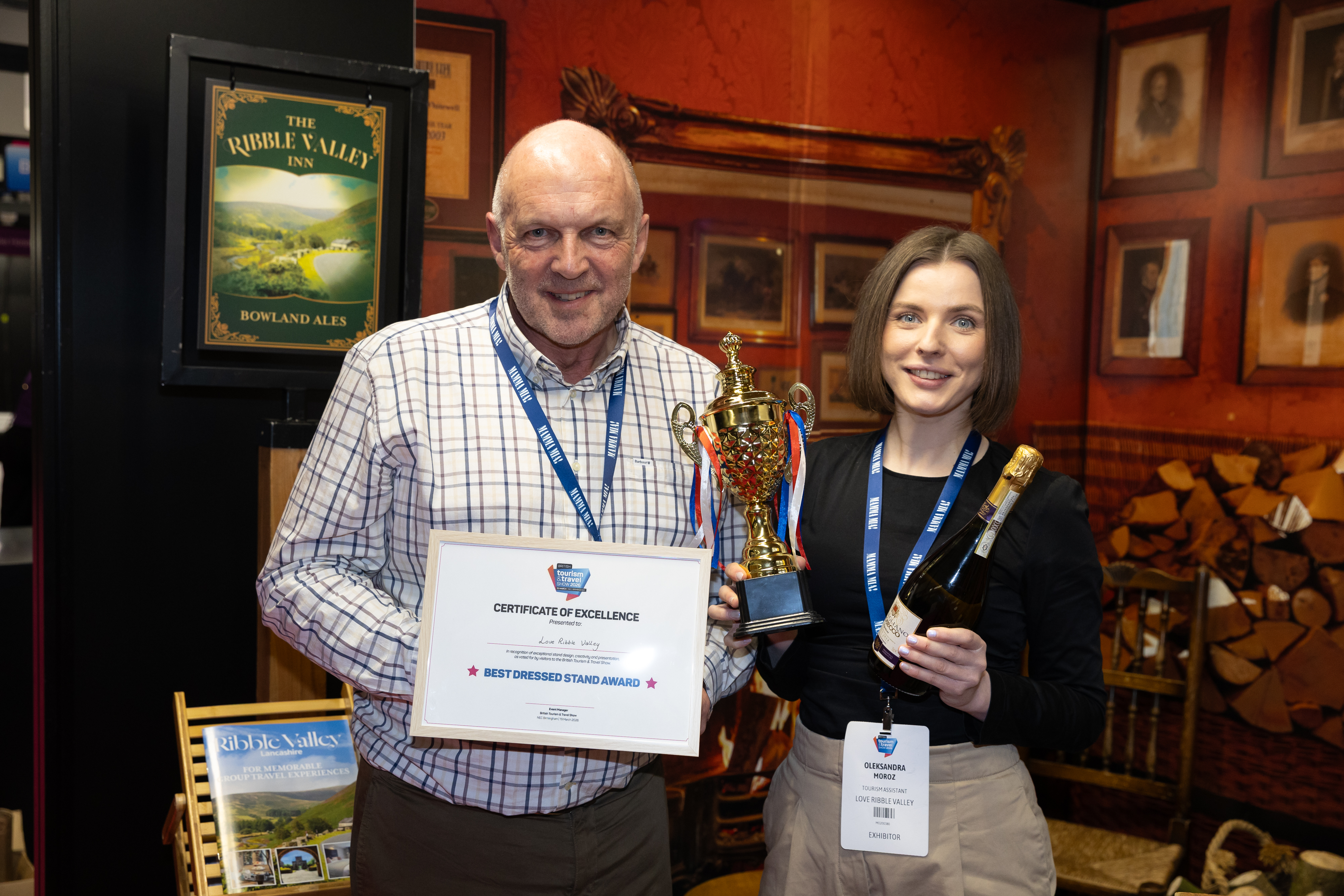 Tom Pridmore and tourism assistant Oleksandra Moroz receiving the best trade stand at the British Tourism and Travel show
